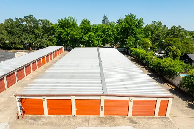 Outdoor, drone view of self storage units. Medium size, orange doors in Orangevale, CA, Drive up access at Devon Self...