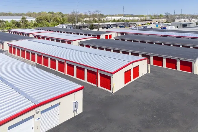 Outdoor, drive up storage units with red doors in Hendersonville at Devon Self Storage - Main Street