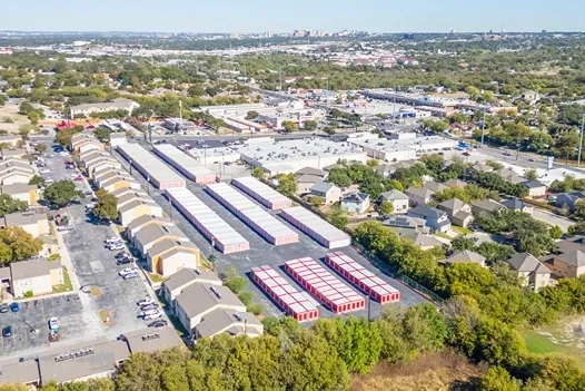 Aerial view of self storage facility with multiple unit rows surrounded by residential neighborhood