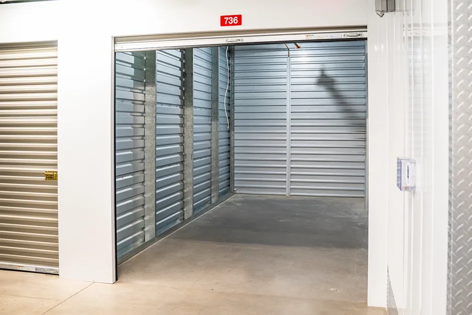 Climate-controlled storage unit interior with roll-up door open for loading