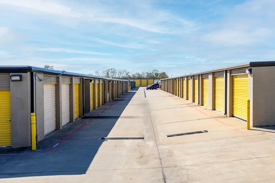 Outdoor, drive up storage units. Wide lanes. Yellow doors. Devon Self Storage Fairway Plaza
