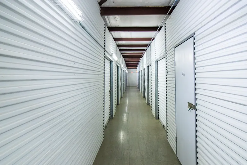 Indoor storage, hallway storage with storage units in Pasadena, Texas. White units. Devon Self Storage Fairway Plaza