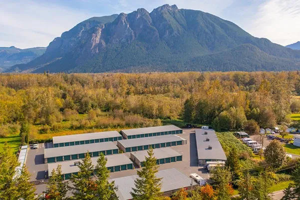 Self storage facility surrounded by mountains and forest with outdoor drive-up storage units