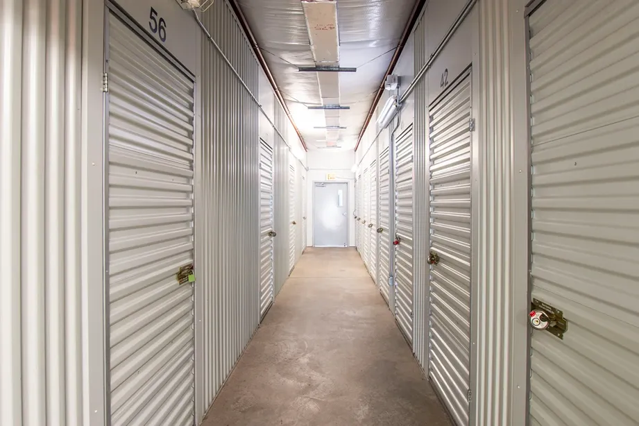 Indoor self storage hallway with secure roll-up units on both sides