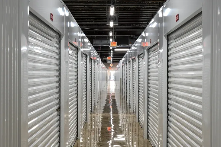 Climate-controlled storage corridor with fire safety equipment and overhead lighting