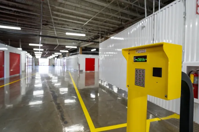 Interior drive-through storage lane with keypad access system and marked traffic lanes