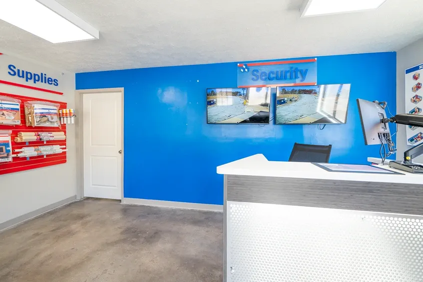 Self storage office with customer service desk and security monitoring system
