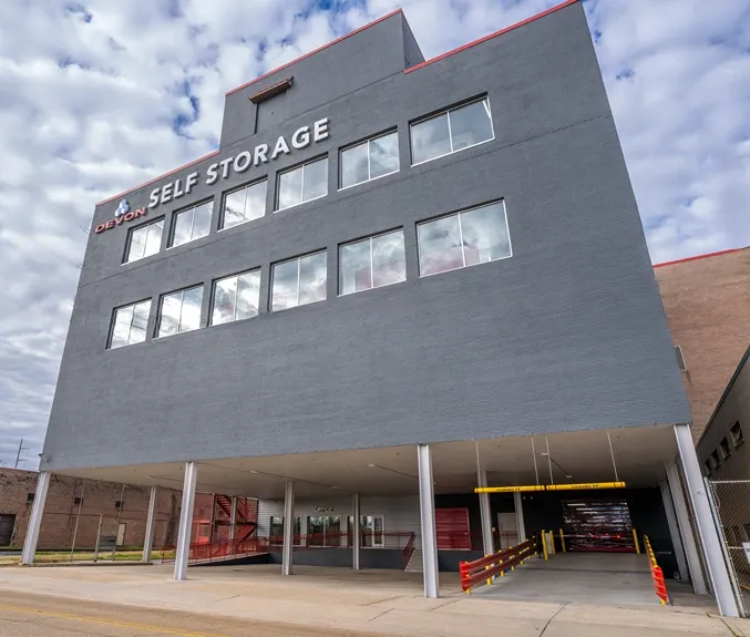 Angled exterior view of multi-story self storage facility with drive-through access