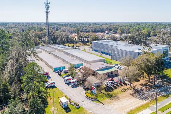 Aerial view of self storage facility near main road with multiple unit buildings