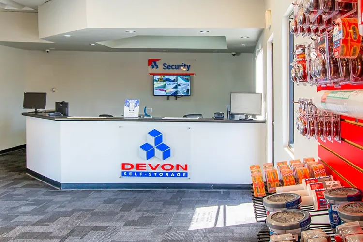 Front desk with Devon Self Storage logo. 