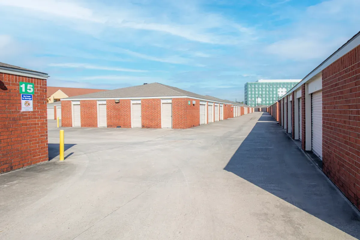 Secure gated entrance at Devon Self Storage with keypad access and U-Haul truck parked inside facility