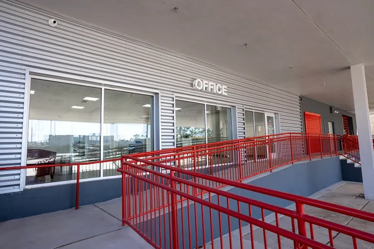 Accessible office entrance with ramp and railings at self storage facility