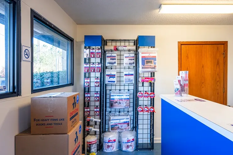 Self storage office interior with moving supplies, packing materials, and customer service counter