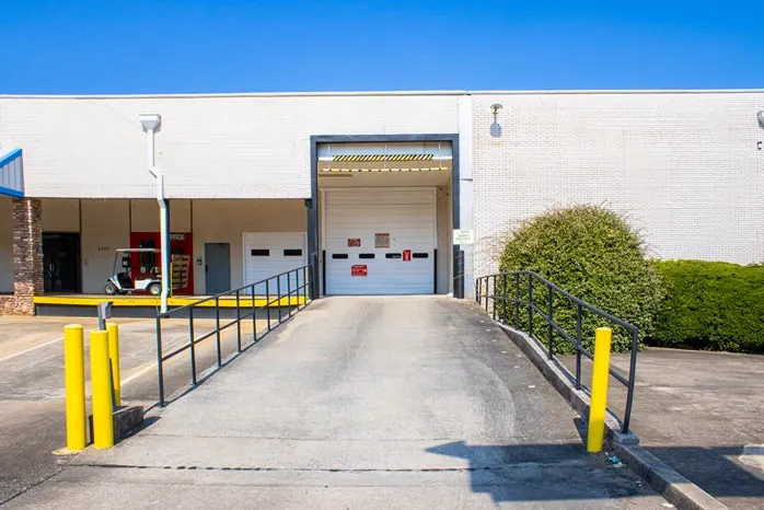 Secure drive-in access point with large overhead door for indoor storage facility