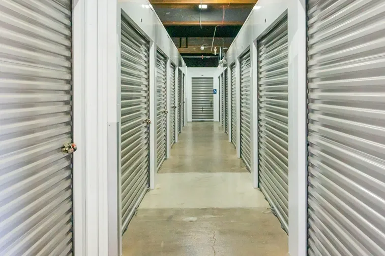 Climate-controlled indoor storage hallway with roll-up unit doors