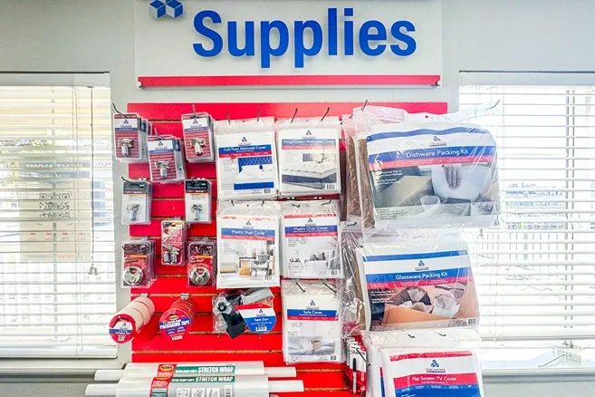 Moving and packing supplies display including mattress covers, tape, and packing kits