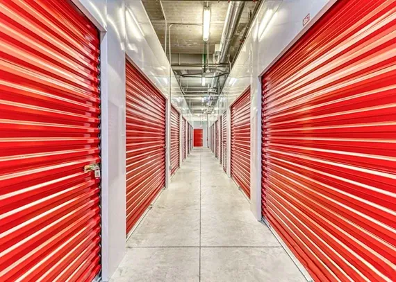 Indoor self storage hallway with secure roll-up unit doors