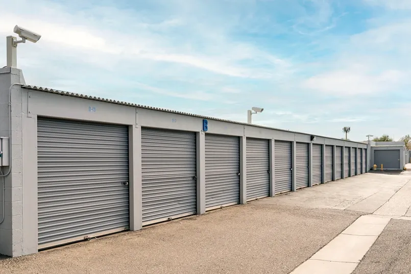 Drive-up storage units with roll-up doors and wide access lanes