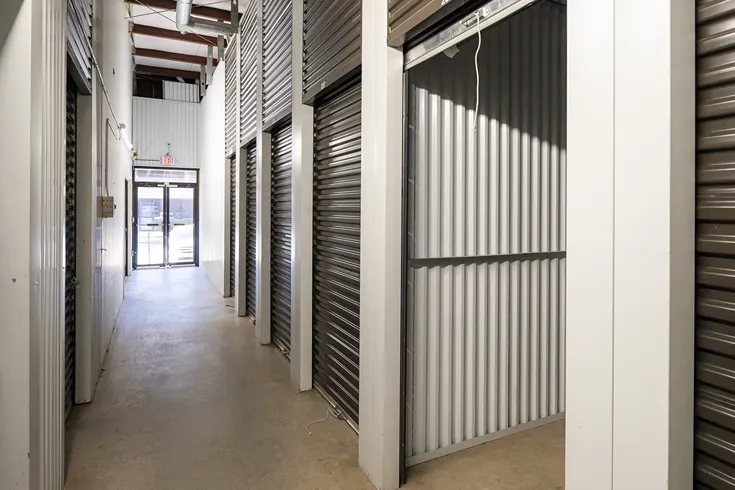 Devon Self Storage - Peachtree Corners, open storage unit, medium size. Grey door and white walls. Views of entrance to...