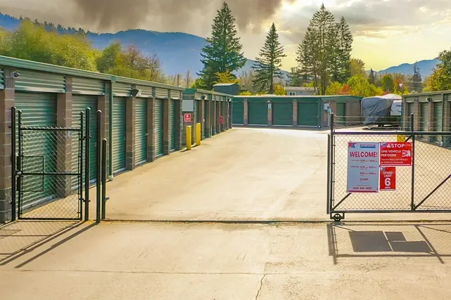 Gated self storage facility entrance with secure keypad access and wide drive lanes