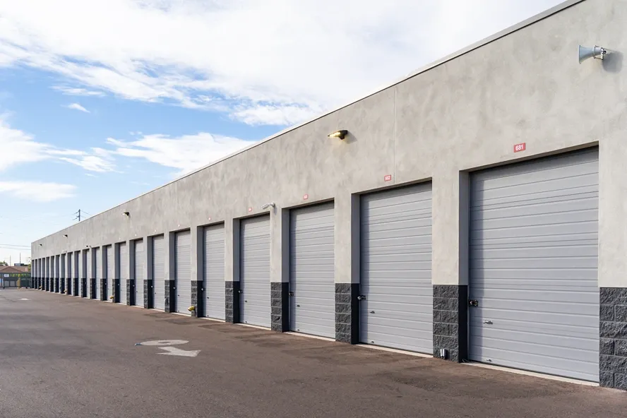 Drive-up storage units with roll-up doors and easy vehicle access lanes
