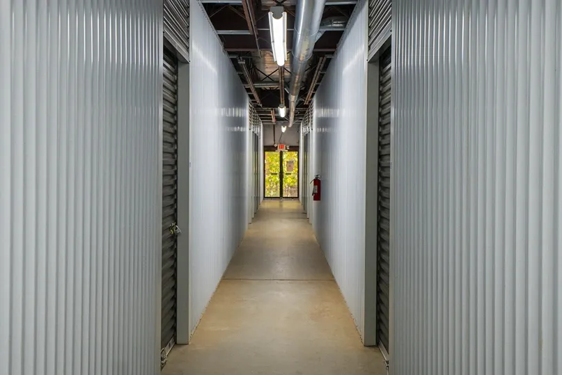 Grey walls inside Devon Self Storage - Peachtree Corners, Grey doors to storage units. View of entrance and exit.
