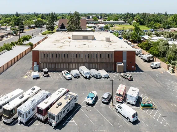 RV and vehicle storage parking area beside multi-level storage building