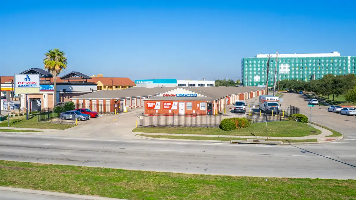 Devon Self Storage facility exterior view from street with fenced perimeter and office building