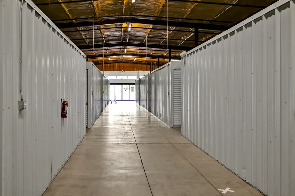 Indoor storage corridor with wide access lanes and secure unit rows