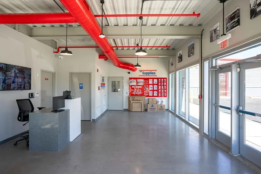 Devon Self Storage - Admiral Wilson, NJ office area with tv for security and wall of storage supplies