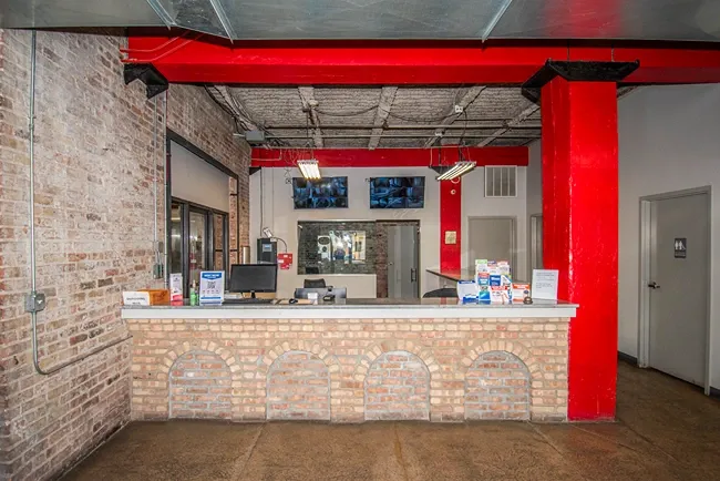 Self storage office with customer service desk and security monitoring system