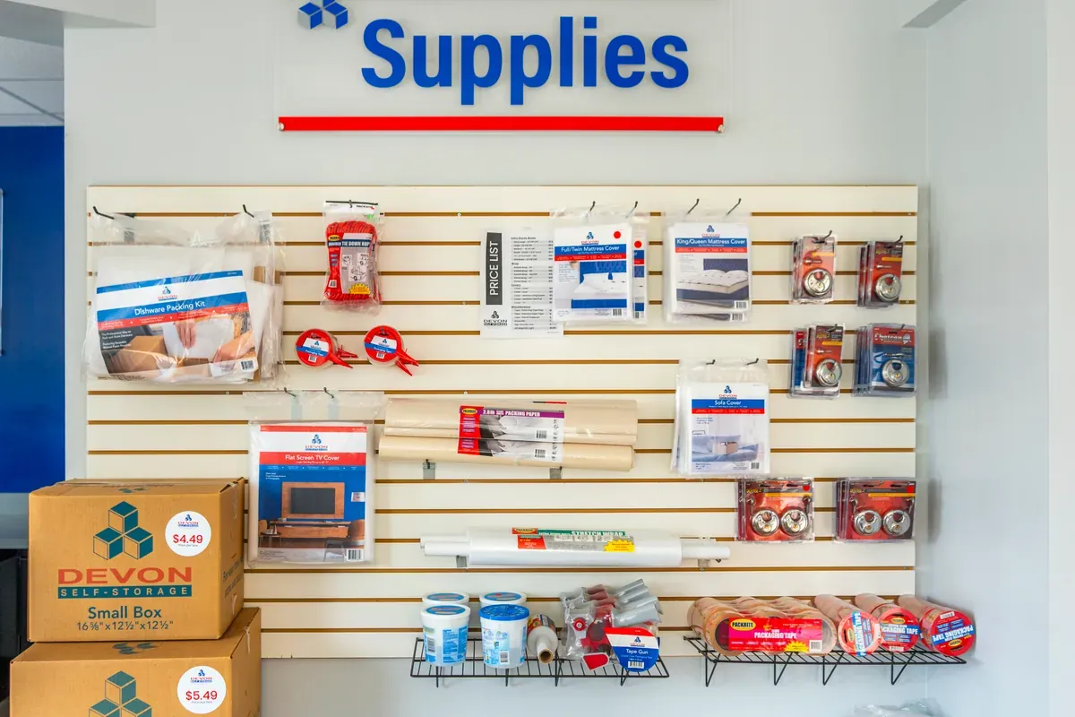 Moving and packing supplies display including boxes, tape, mattress covers, and packing materials at Devon Self Storage