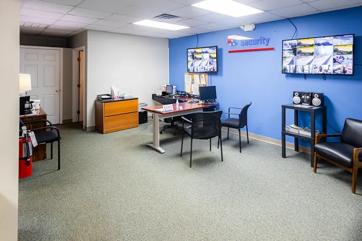 Self storage office with security monitoring screens and customer service desk