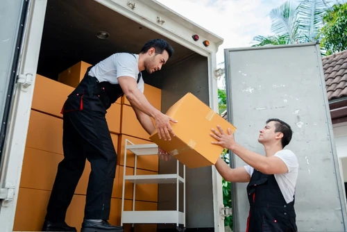 Movers moving boxes on a truck