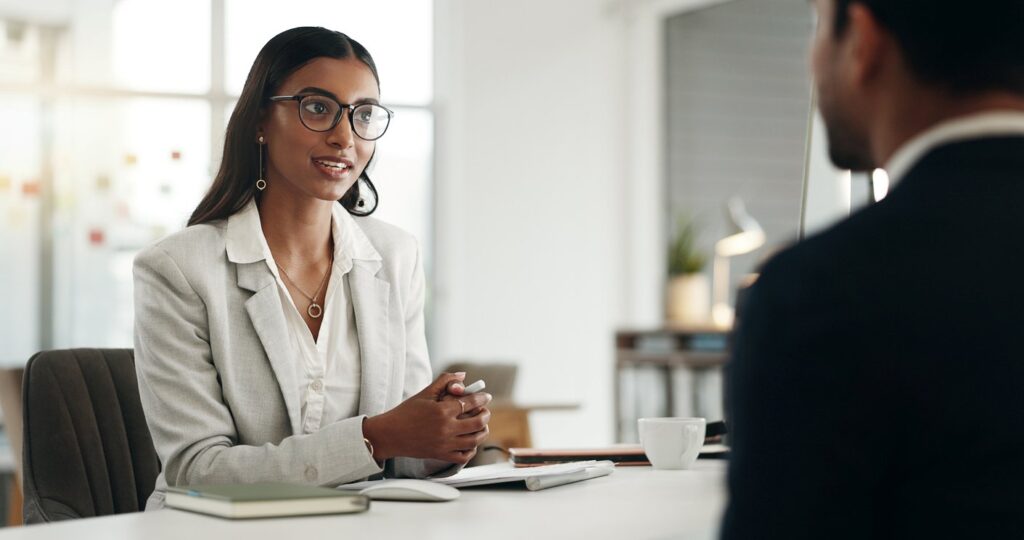 A woman and a man partaking in a job interview.