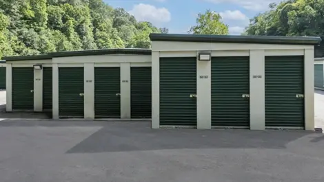 Outdoor walk up storage units Self Storage in Camp Horne, PA, green doors to small unit sizes