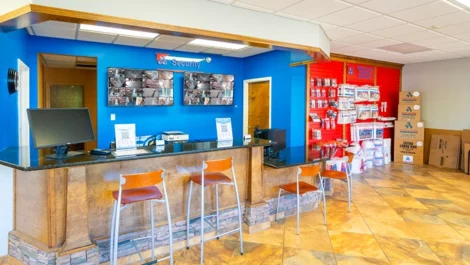 Office at storage facility with storage supplies, plus security tvs on the wall at Devon Self Storage - Athens GA