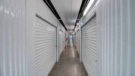 Hallway to storage units, white walls, clean facility Self Storage in Greenville, TX, on Wesley Street