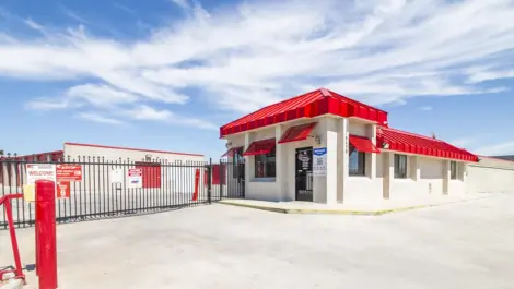 Secure, gated storage entrance to drive up storage units in West Apple Valley, CA, at Devon Self Storage - West Apple Valley