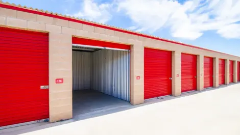Up close of opened, large storage unit with red doors in Apple Valley, CA, at Devon Self Storage - Highway 18 #1