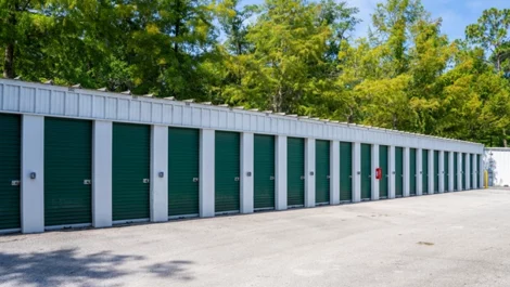 Exterior view of small, medium storage units. Green doors. Drive up access, wide lanes at Devon Self Storage in Highlands, Jacksonville, FL