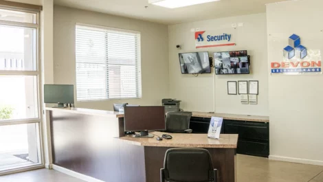 Office area with security camera tvs on the wall at Devon Self Storage - Marconi in Sacramento, California