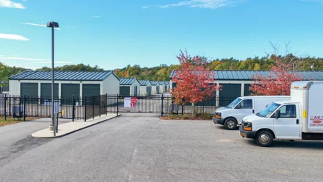 Self Storage in Falmouth, ME, rental trucks parked outside.