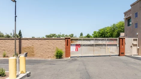 Secure, gated self storage facility with tall brick wall with keypad entry at Devon Self Storage - Marconi in Sacramento, CA