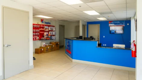 Office area with storage supplies and a security wall at Devon Self Storage in Highlands, Jacksonville, FL