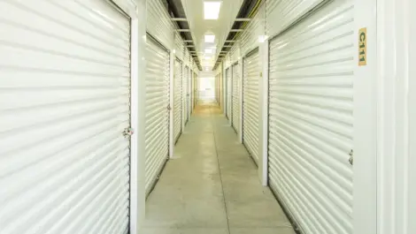 Hallway to storge units, large units with white doors in Ardmore, OK, at Devon Self Storage - Ardmore