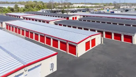 Outdoor, drive up storage units with red doors in Hendersonville at Devon Self Storage - Main Street
