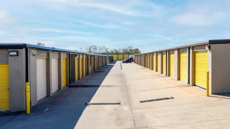 Outdoor, drive up storage units. Wide lanes. Yellow doors. Devon Self Storage Fairway Plaza