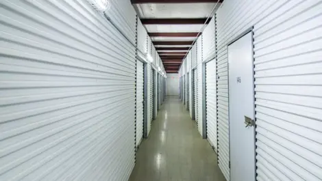 Indoor storage, hallway storage with storage units in Pasadena, Texas. White units. Devon Self Storage Fairway Plaza