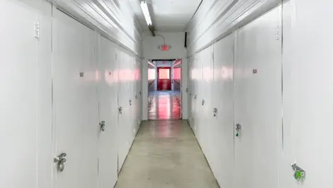Hallway of small storage units in Hendersonville at Devon Self Storage - Main Street with white doors